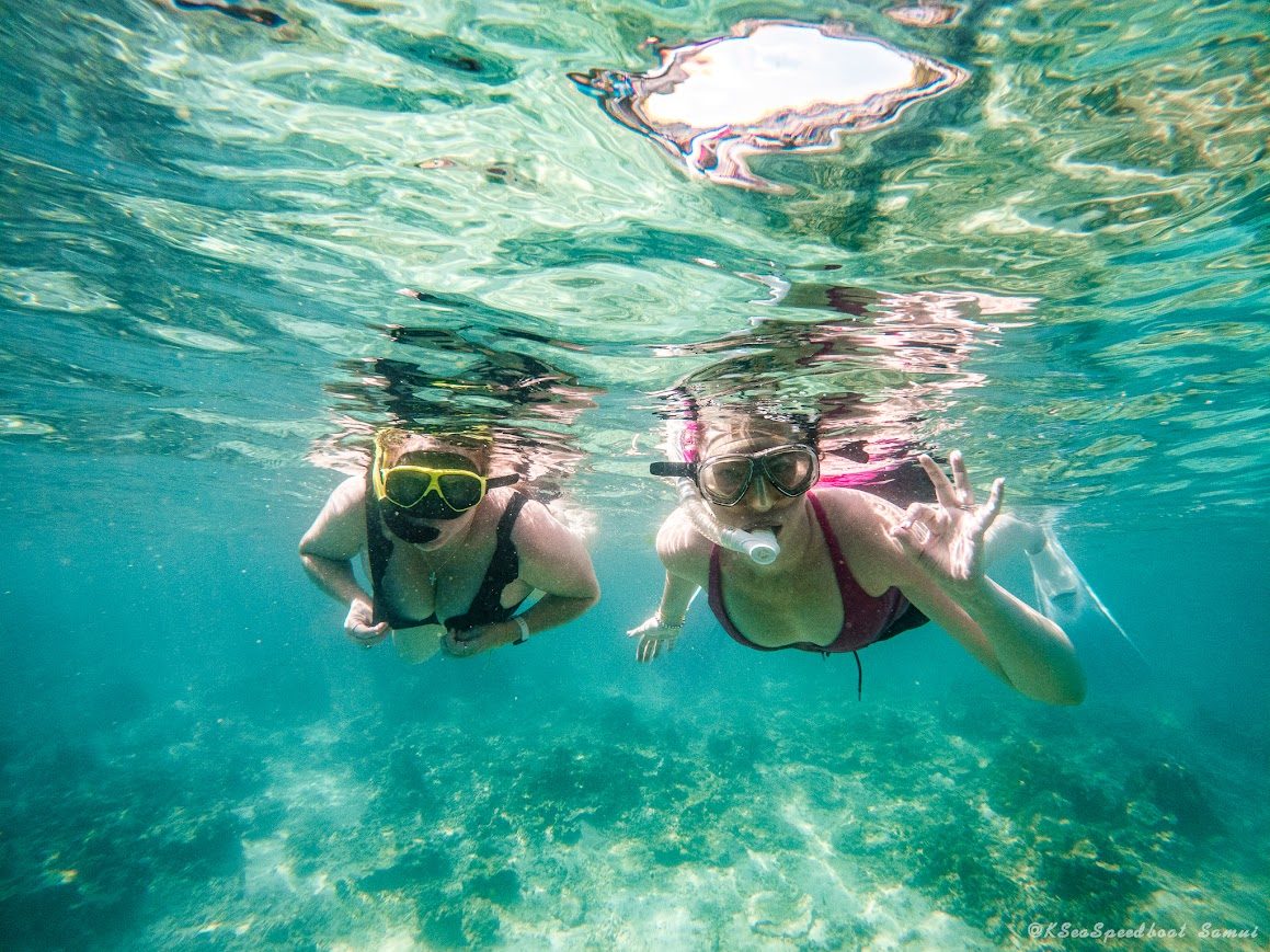 Two ladies snorkelling in clear turquoise water