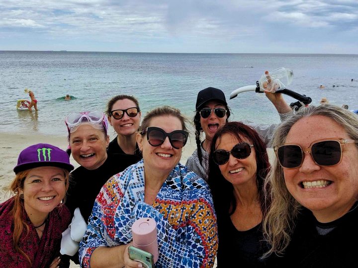 A beach selfie of smiling Ladies HQ women