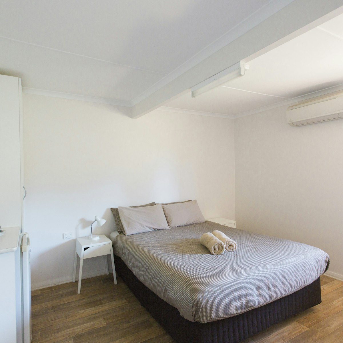 A queen bed in the Exmouth apartments
